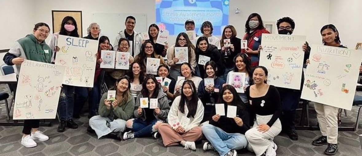 Sociology club holding up signs